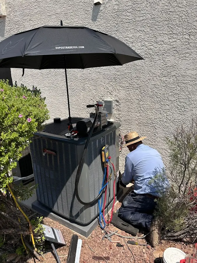 HVAC technician performing outdoor AC maintenance in Bladensburg
